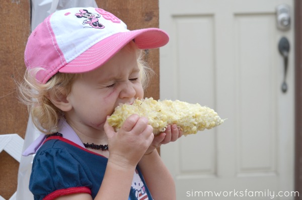 corn on the cob with herb butter eating