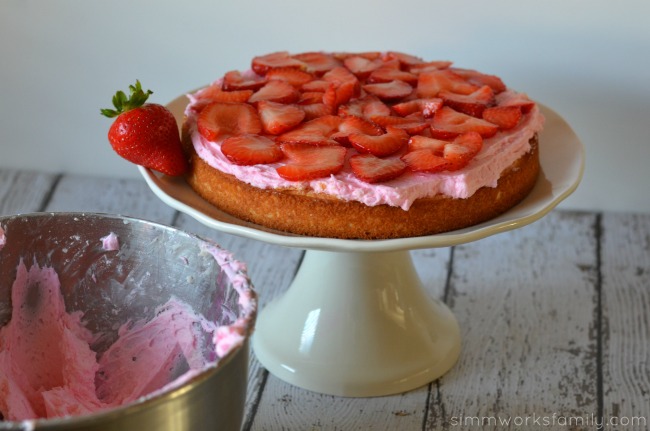 white party cake with strawberry layer