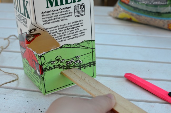 DIY Milk Carton Bird Feeder - add stir stick