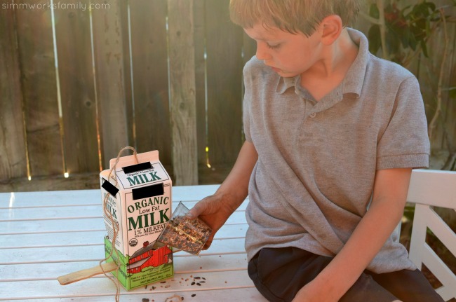 DIY Milk Carton Bird Feeder - adding bird seed