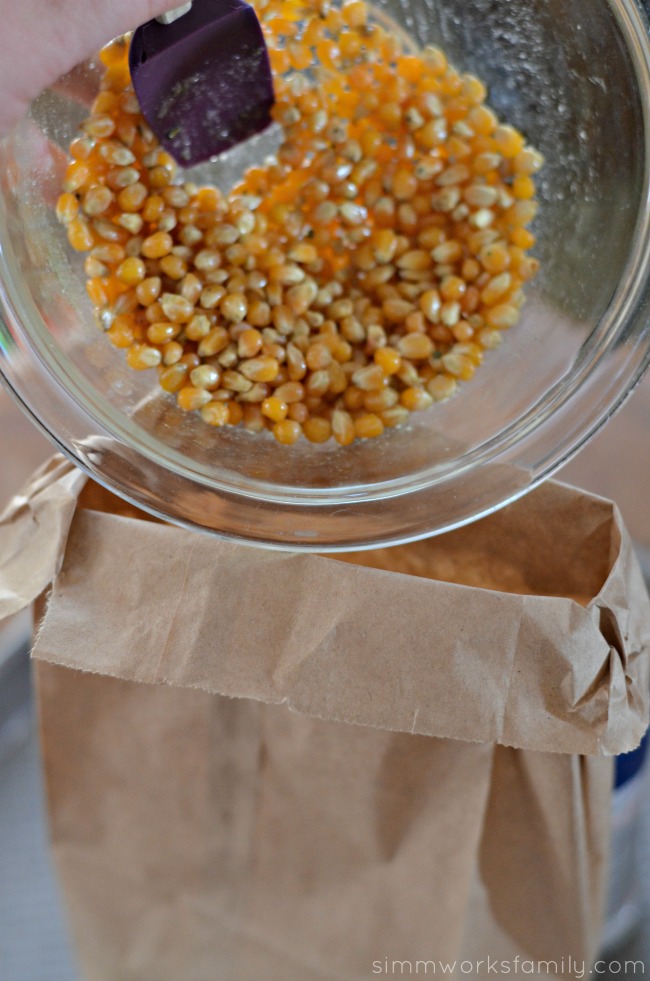 Homemade Microwavable Ranch Popcorn in a Bag pour seasoned kernels in bag